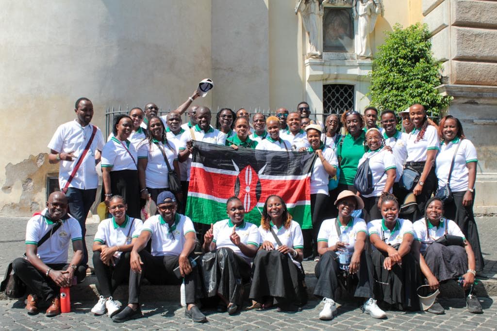The choir holding the Kenyan flag outside a church in Rome during their pilgrimage