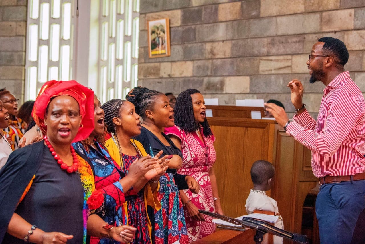 Choristers singing as the conductor directs during Sunday Mass at St. Paul's University Chapel